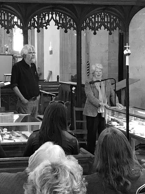 Woman addressing an audience in a church.